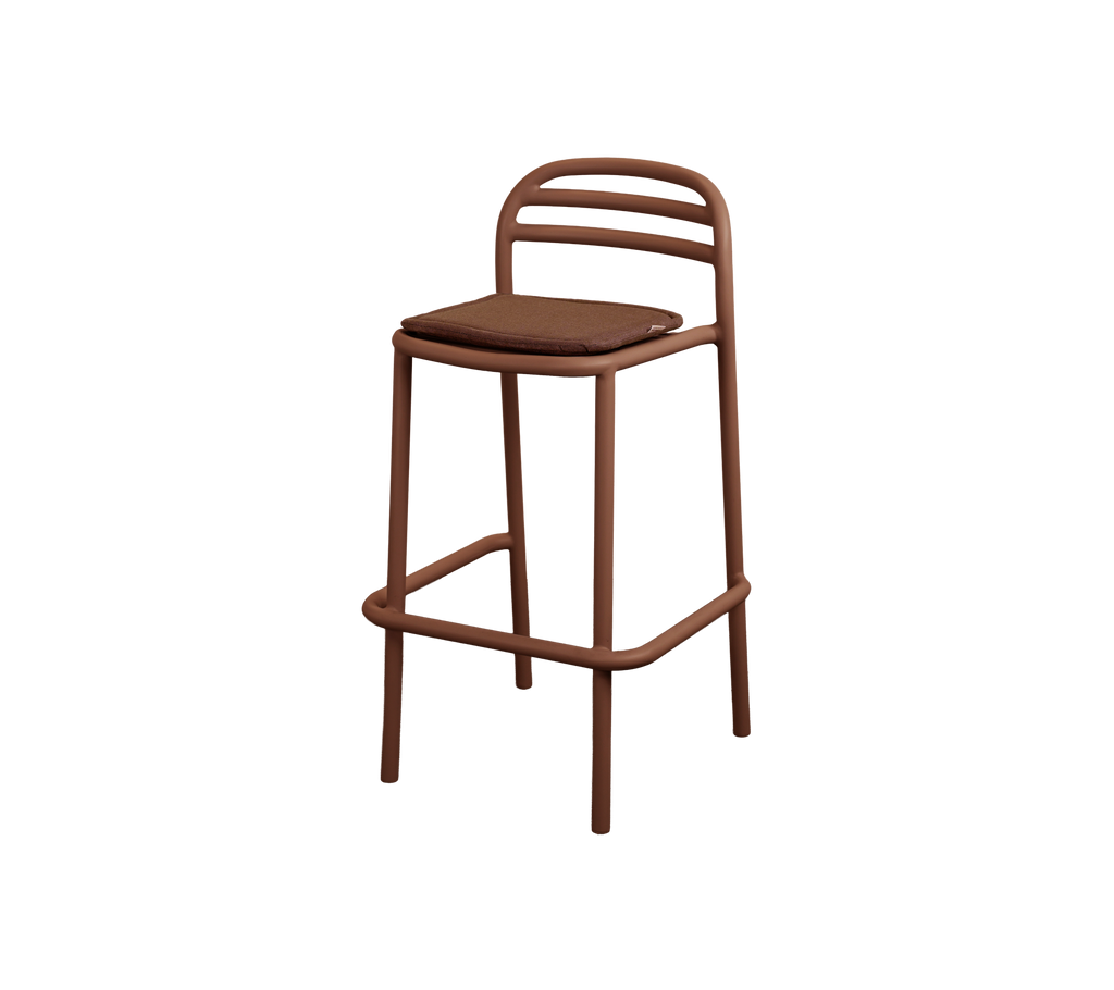 Modern barstool with a desert red cushion.
