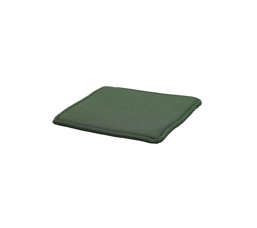 Light green cushion placed on a flat surface.