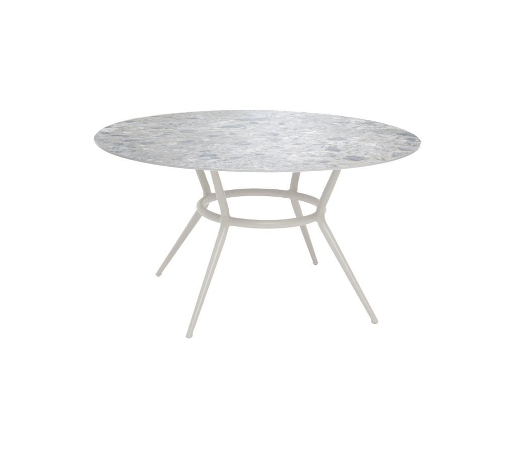 Round table with a multi-color top and light-colored base.