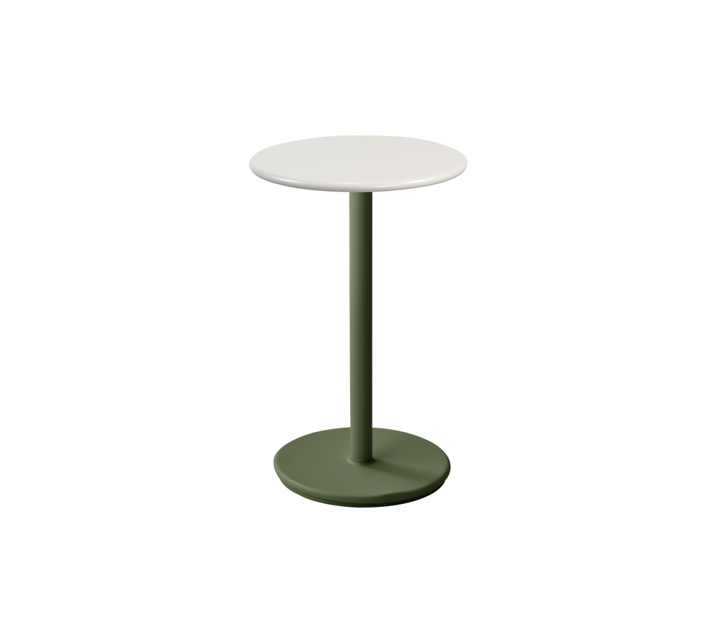 Modern dark green table with a white top in a lounge setting.