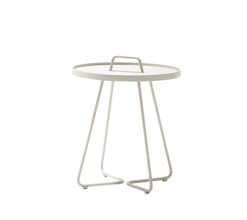Sand side table with a sleek design and minimalist handle.