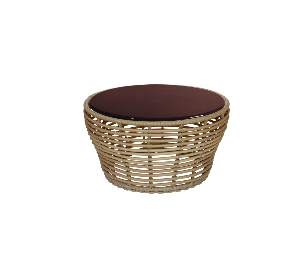 Round table with a burgundy top and natural woven base.