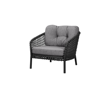 A stylish, black woven chair with comfortable gray fabric cushions, designed for relaxation and modern aesthetics.