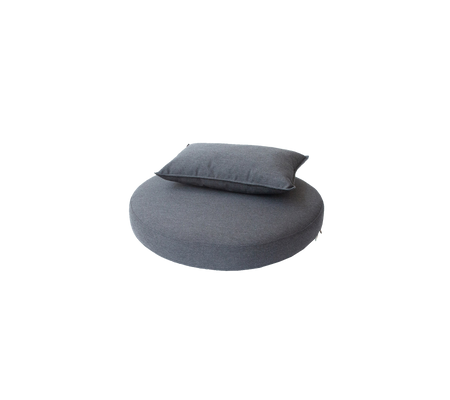 Round cushion in a dark gray fabric, topped with a smaller rectangular pillow, designed for comfort and relaxation.