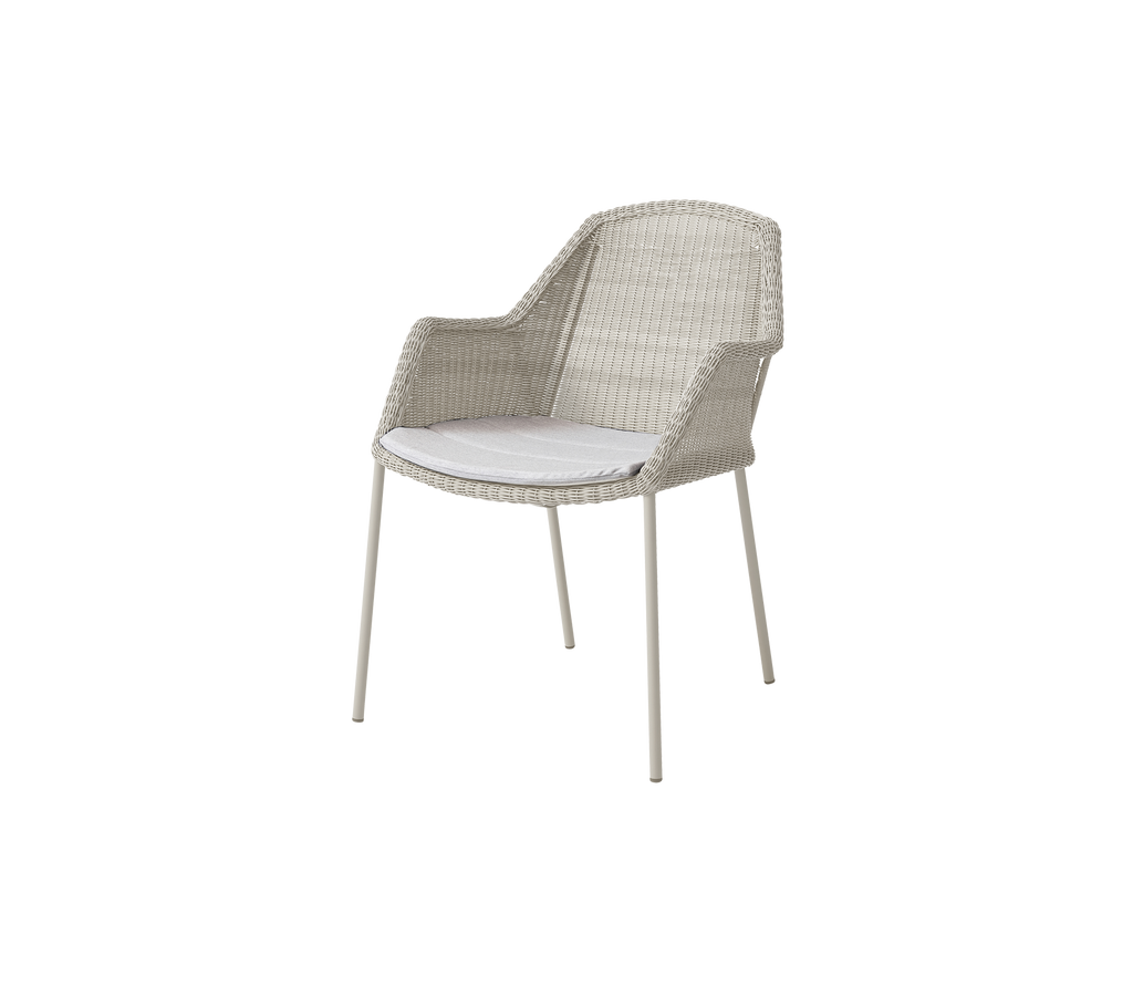 Modern chair with light grey cushion in a simple design.