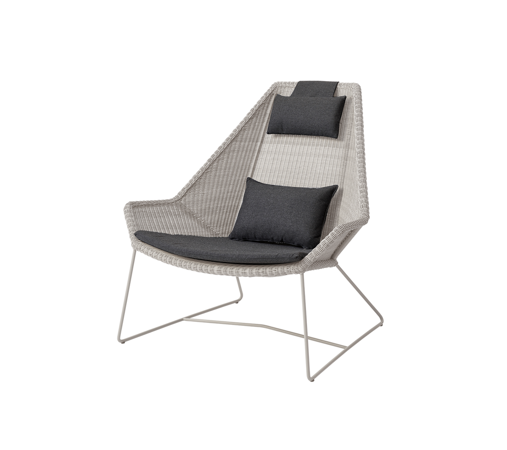 Modern sand chair with black cushions in a contemporary design.