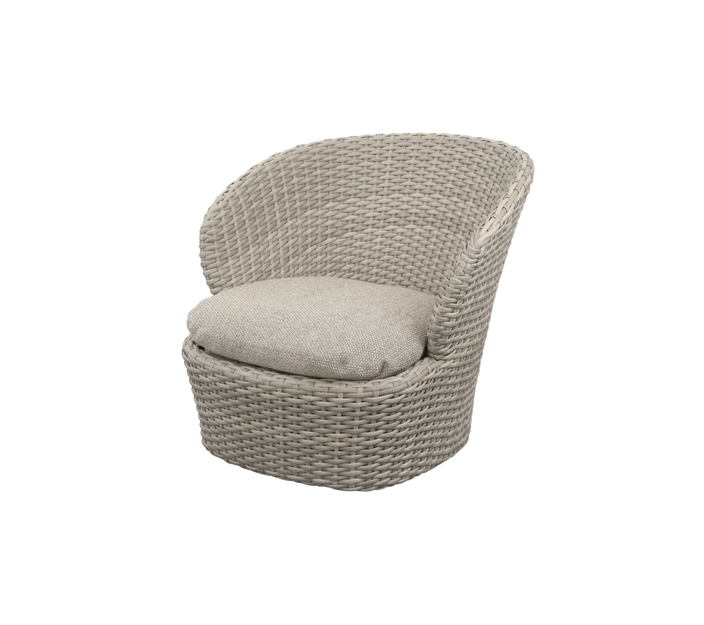 Cozy, curved chair with a woven design and plush cushion, offering a comfortable seating option for relaxation.