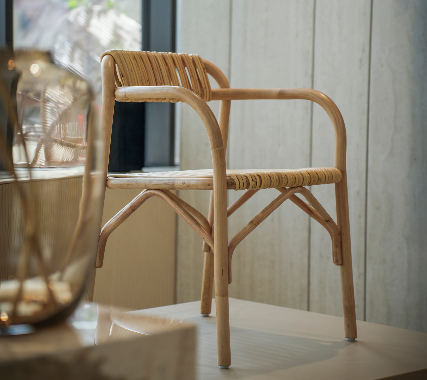 Modern bamboo chair with a woven seat in a bright interior space.