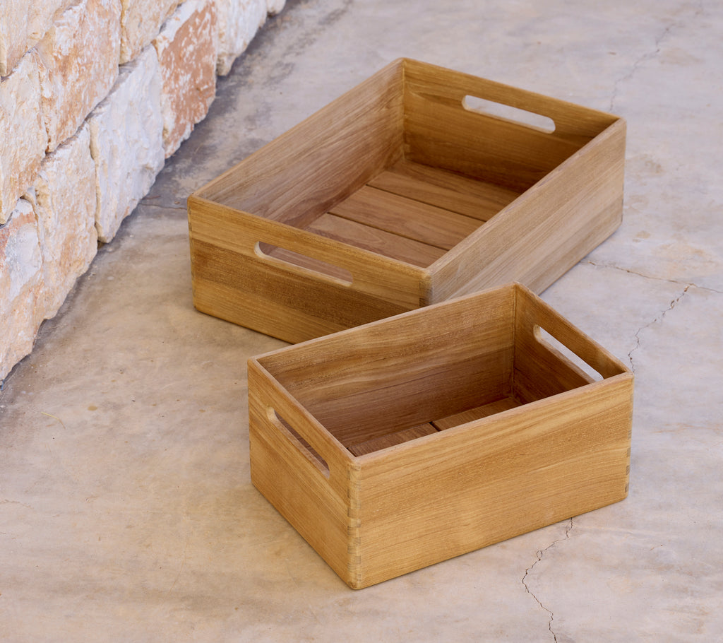Two wooden crates of different sizes placed on a concrete surface.