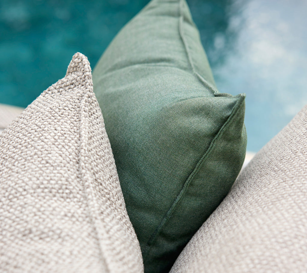 Green and grey cushions arranged together.