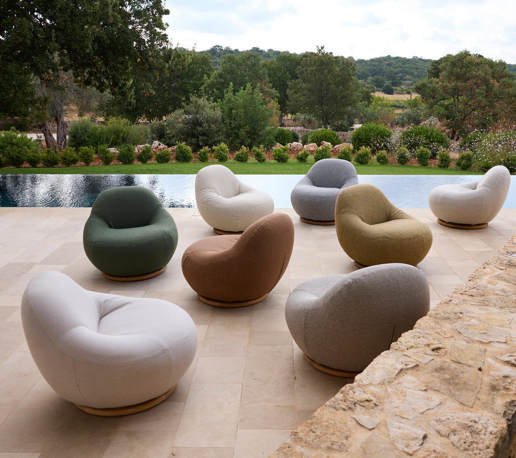 Set of modern chairs in various colors arranged around a poolside.